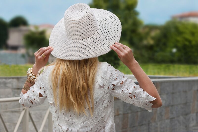 Fashion blogger Aurora Berill wearing an Extyn straw wide brimmed hat and Gianni Accessori statement bracelet