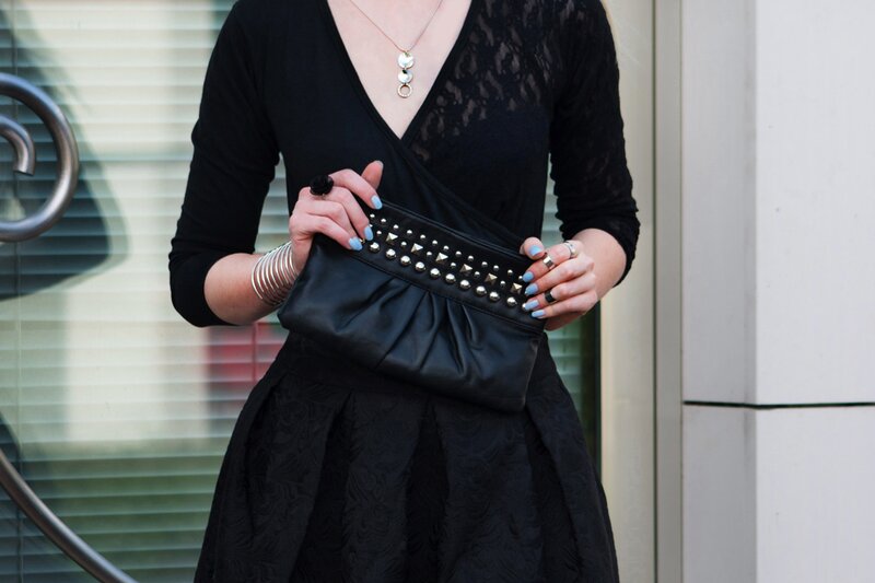 Fashion blogger Aurora Berill wearing a Majique silver cuff bracelet and a black studded clutch