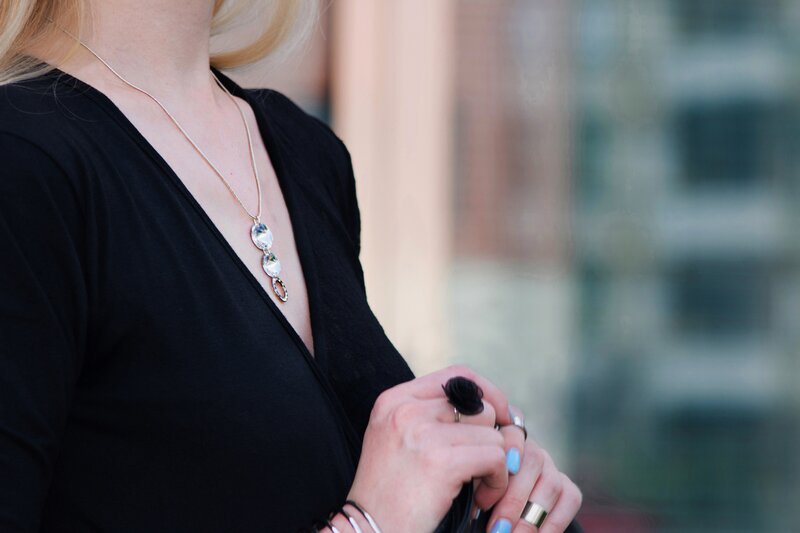 Fashion blogger Aurora Berill wearing a Swarovski diamond necklace and a black rose ring