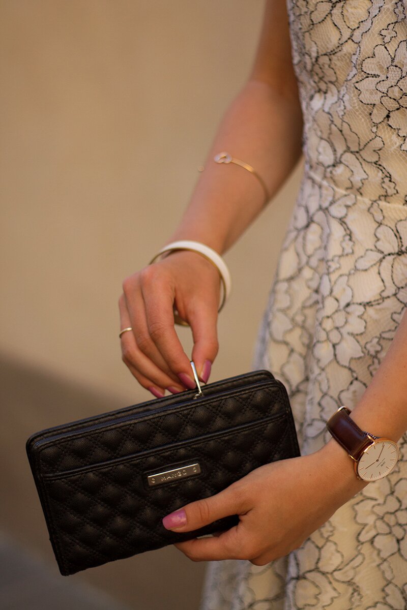 Fashion blogger Aurora Berill holding a Mango wallet and wearing a gold wishbone ring