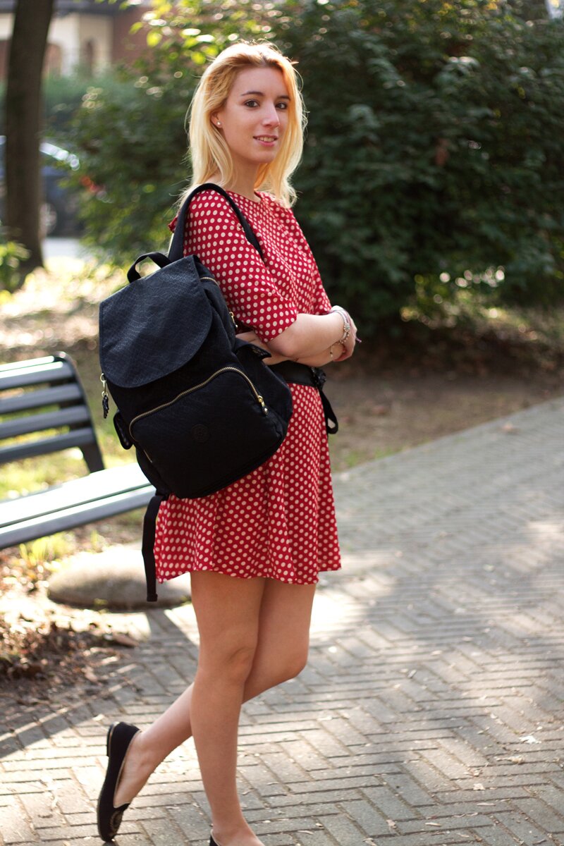 Fashion blogger Aurora Berill wearing a pair of Pittarello loafers with gold embellishments and a Kipling black backpack