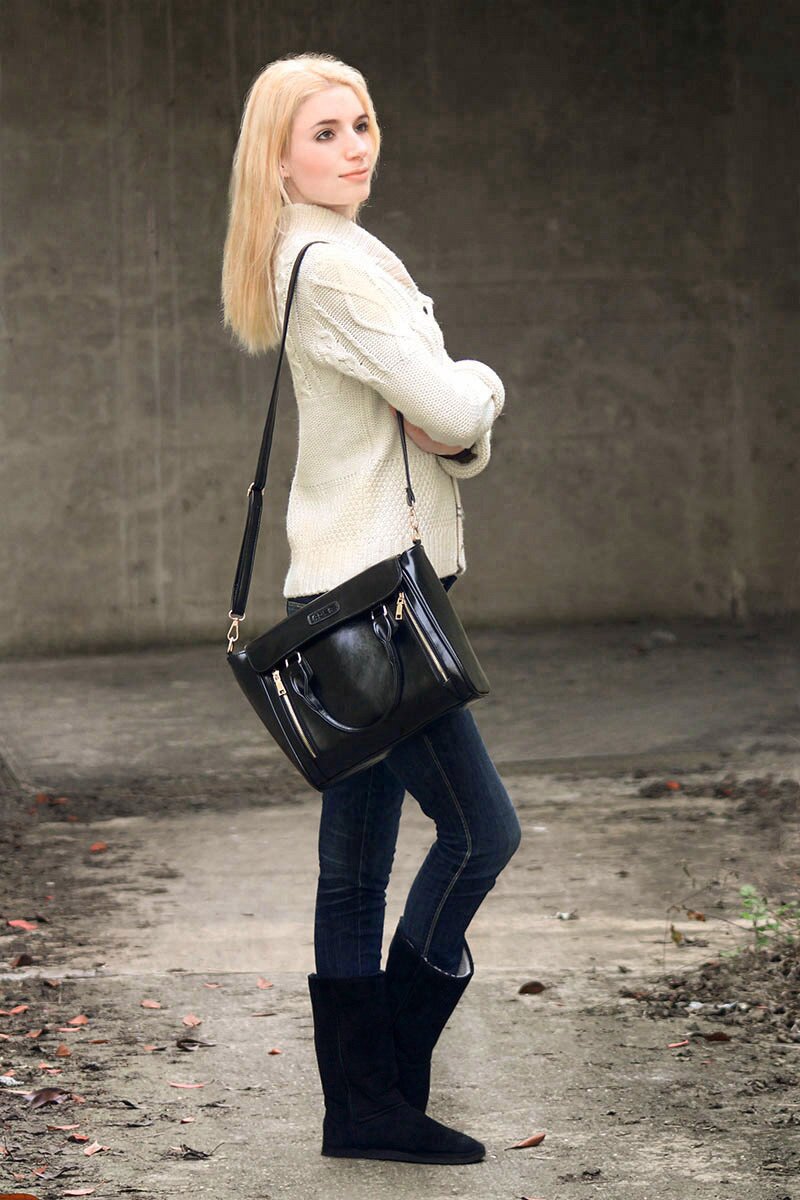 Fashion blogger Aurora Berill wearing a cable knit cardigan paired with dark denim jeans